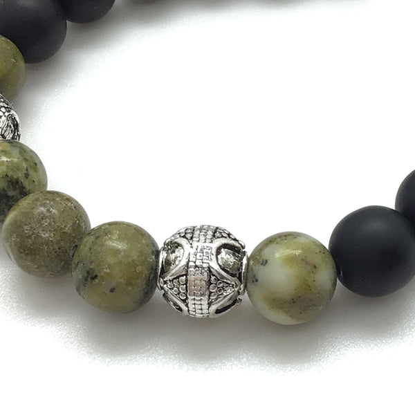 The Grasshopper™ Bracelet features Smooth Yellow Serpentine, Black Onyx, and Antique Silver Finished Bali-style accents.