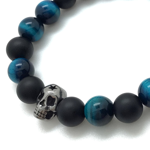 The Midnight™ Bracelet by MancessoriesUSA™ features a durable polished stainless steel skull, onyx and blue tiger eye.