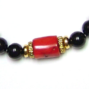 The Explorer Bracelet features red coral, black onyx, 14/20 gold plated rondelles and faceted golden quartz.