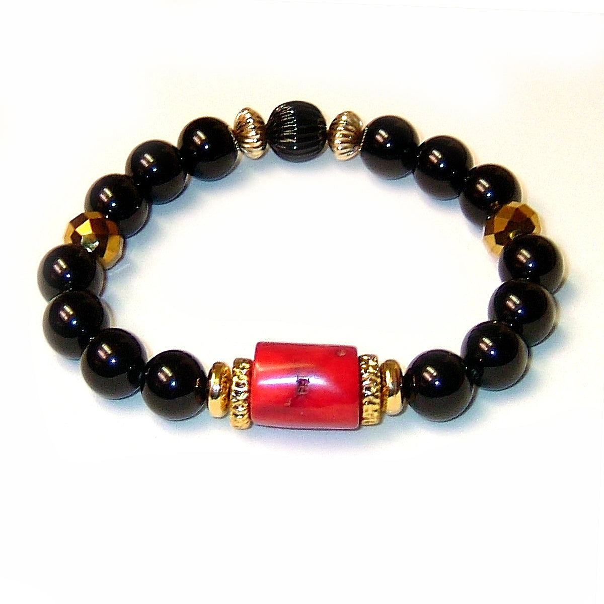 The Explorer Bracelet features red coral, black onyx, 14/20 gold plated rondelles and faceted golden quartz.
