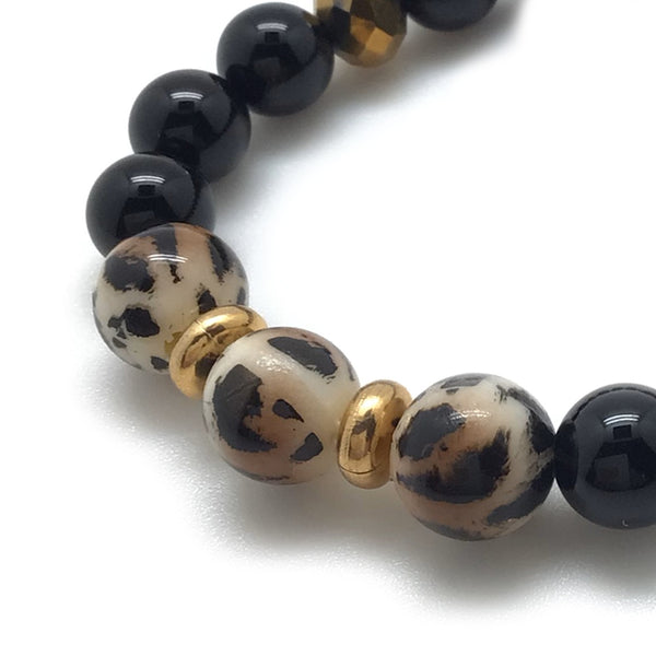 Grrrl Bracelet feartures Leopard Resin Beads, onyx, gold tone facet crystals and 18kt gold plated rondelles.