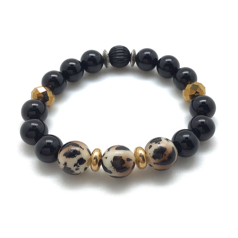 Grrrl Bracelet feartures Leopard Resin Beads, onyx, gold tone facet crystals and 18kt gold plated rondelles.
